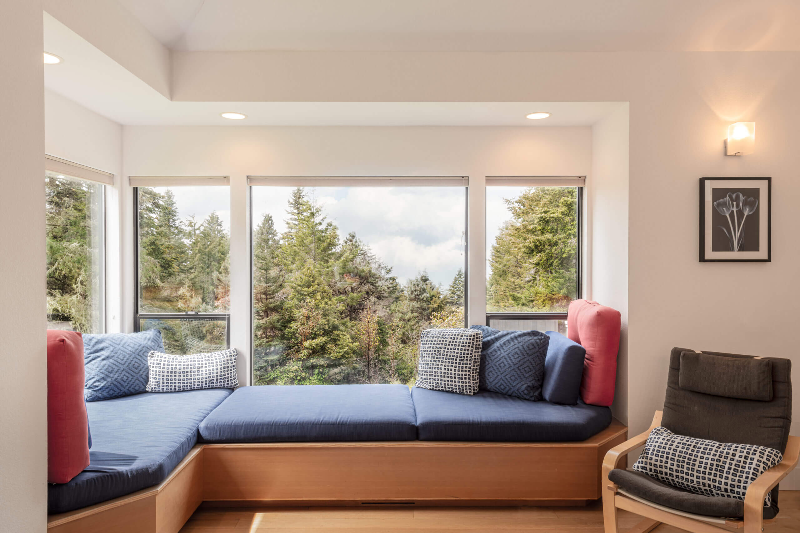 Sea Ridge blue windowseat next to large windows with tree view