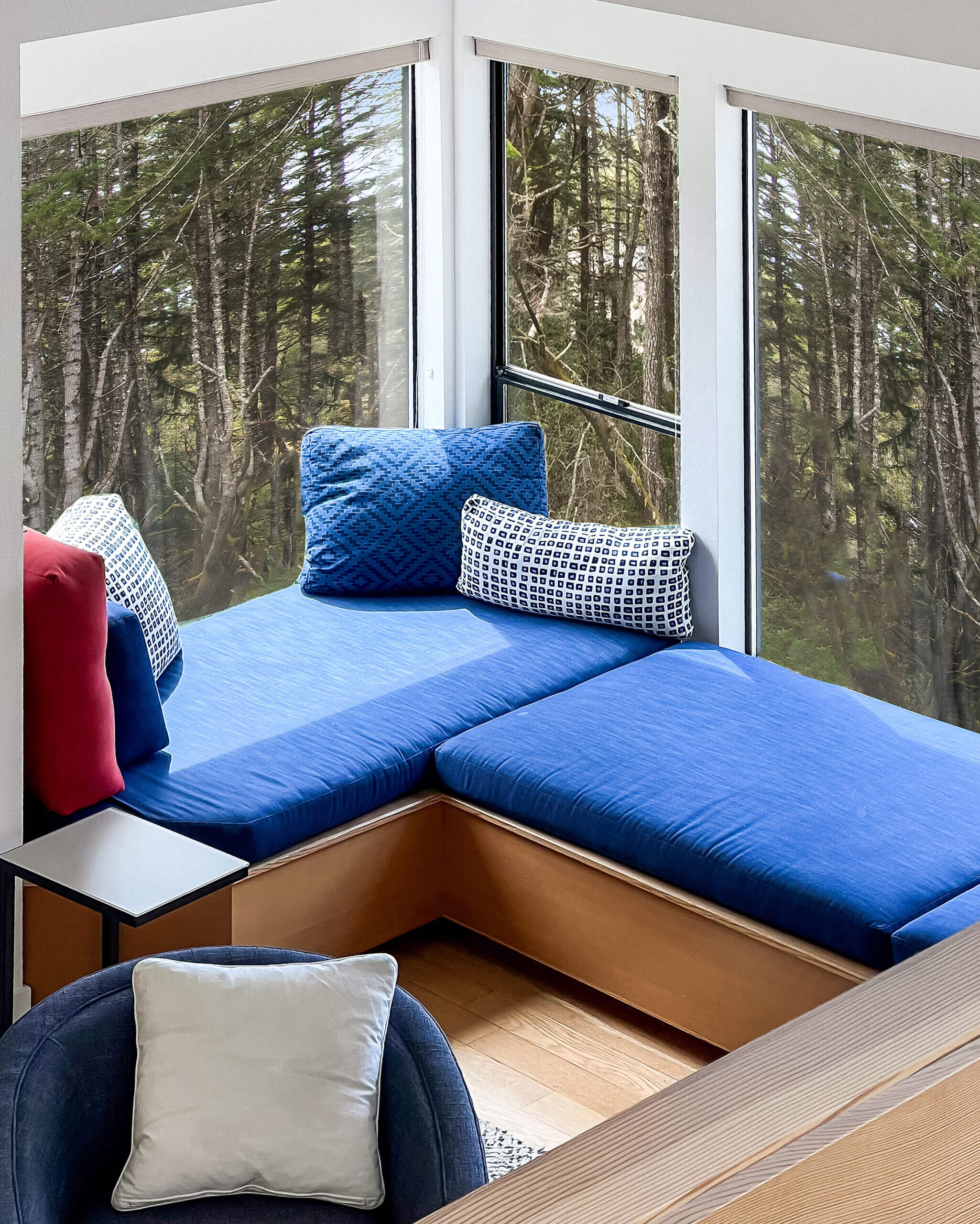 Sea Ridge blue windowseat next to large windows with tree view
