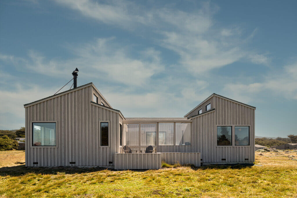 Bella Luna view of back of house, blue sky and meadow