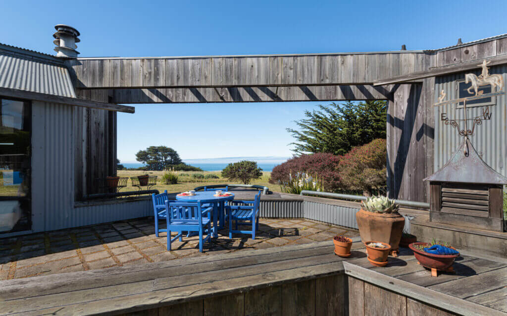 Tin Roof enclosed outdoor dining with view of ocean meadow