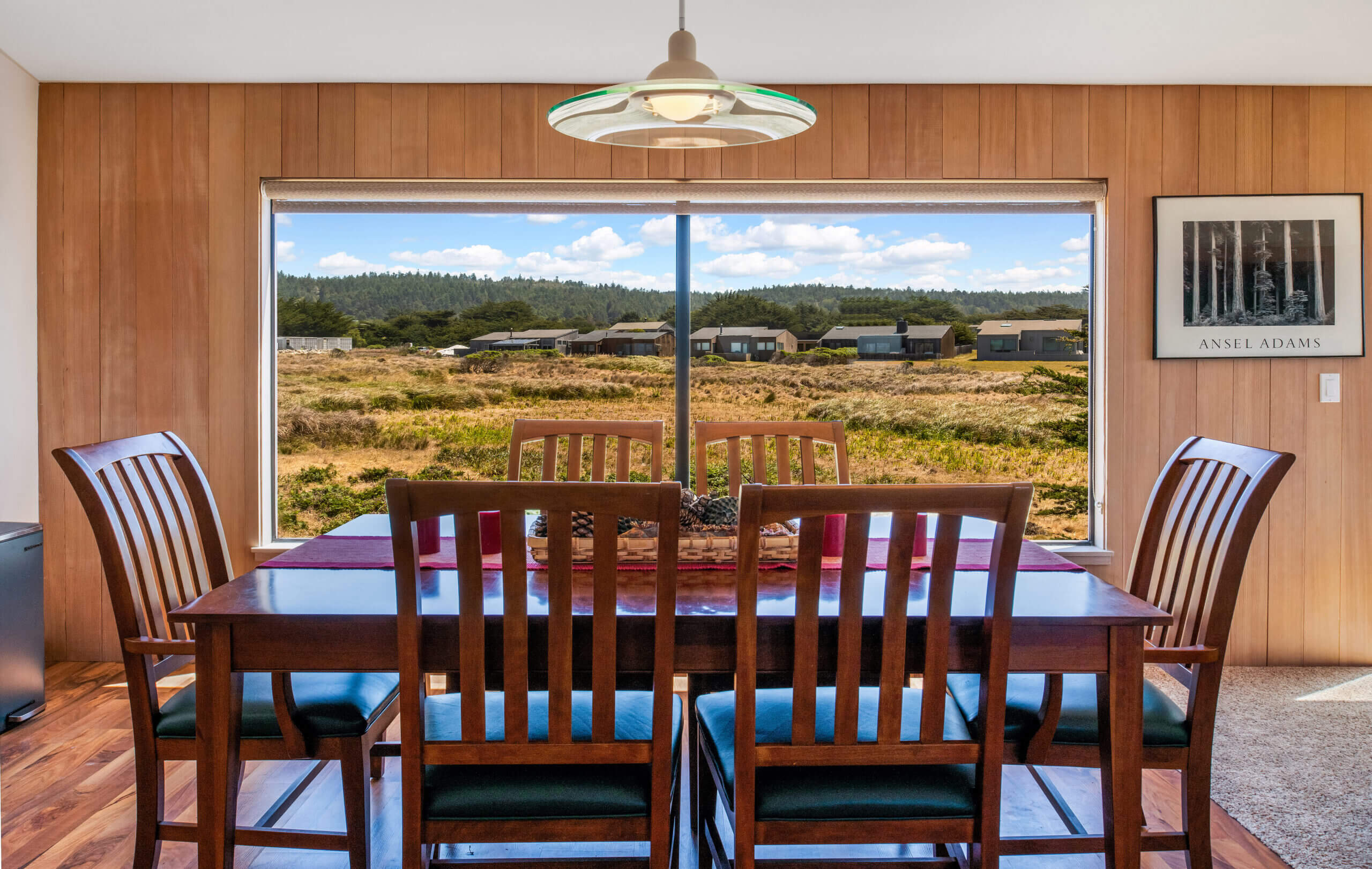 Piper's Dream dining table, large windows with view of meadow