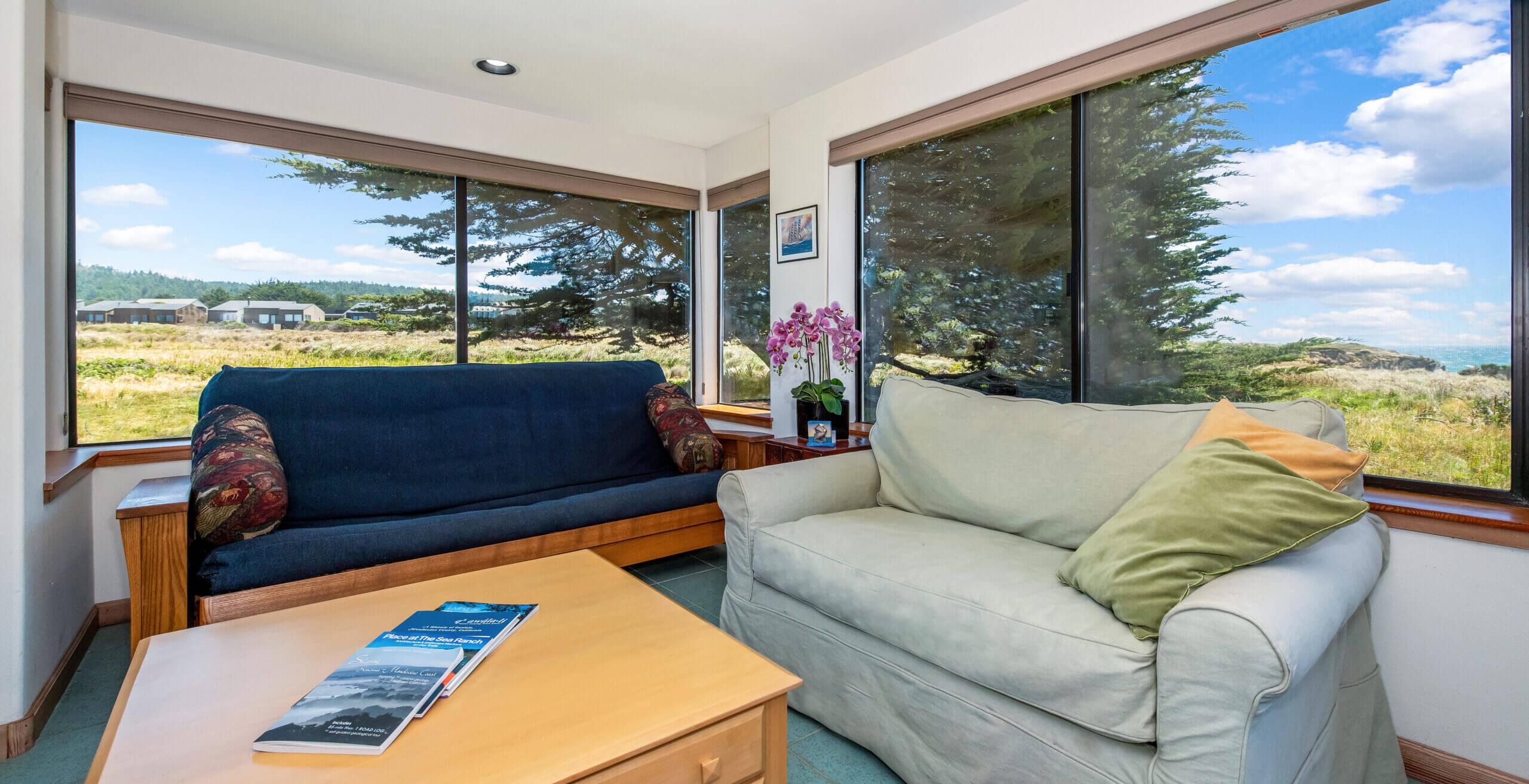 Piper's Dream master sitting space, large windows of ocean meadow