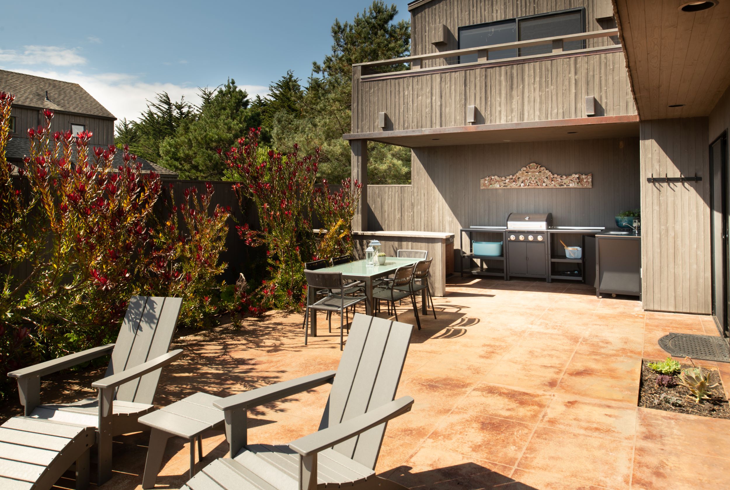 Solstice - outside view of patio with dining table, lounge chairs and grill