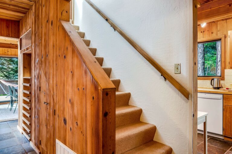 Sea Pony - wood paneled carpeted staircase with white walls