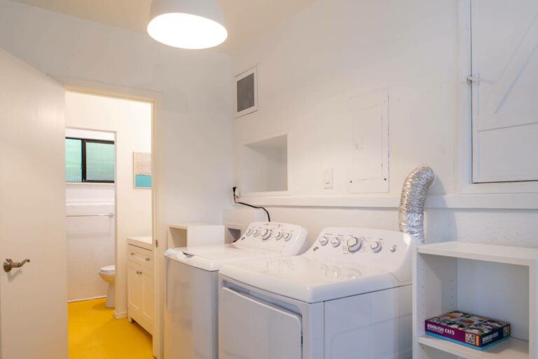 Sea Pony - bright white laundry room with small 1/2 bath