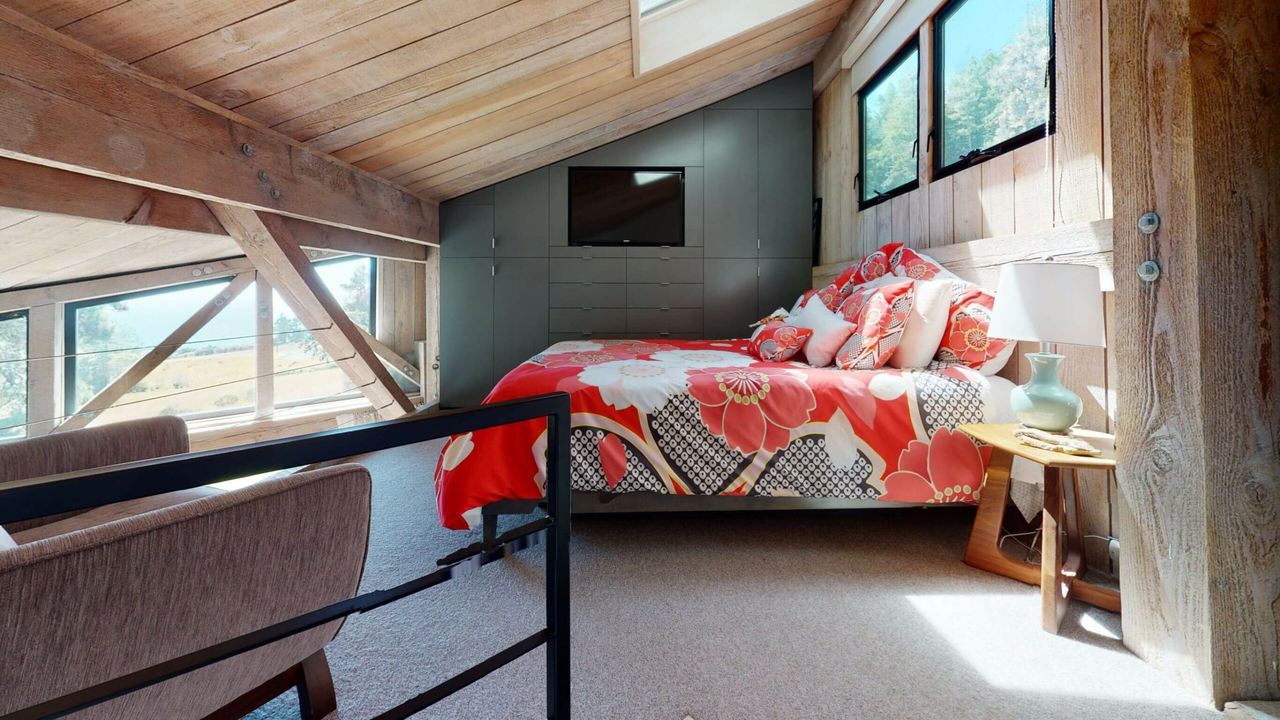 Seaview loft bedroom with wood ceilings