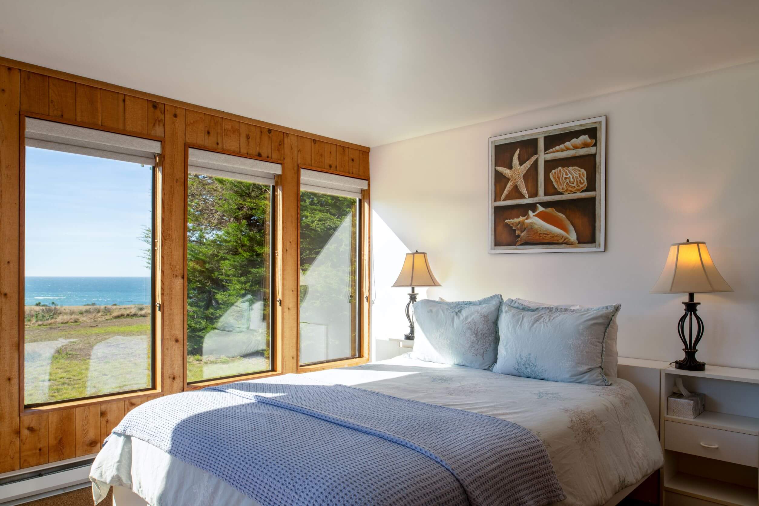 Lighthouse - bright queen bedroom with window view of ocean meadow