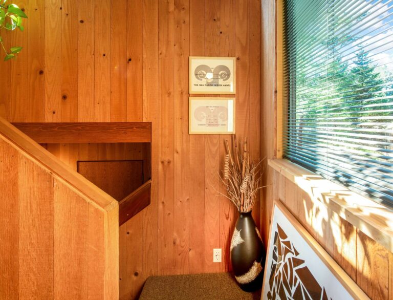 Paradiso - bright wood paneled staircase with large window looking onto trees