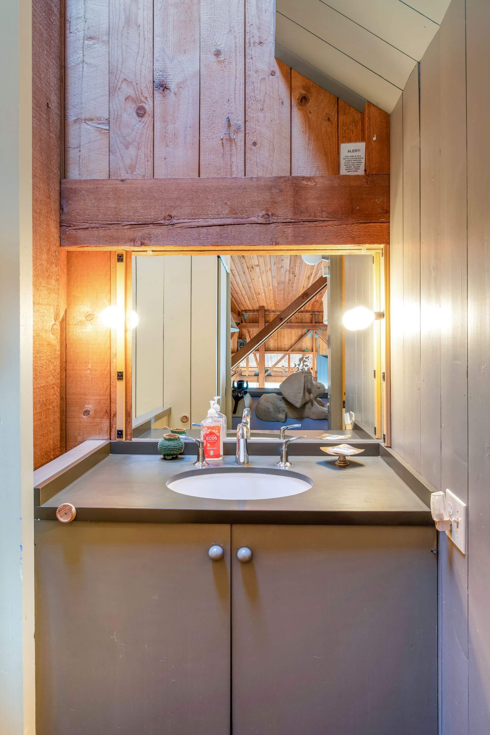 Moore Condo #9 - small bathroom with sink and mirror.