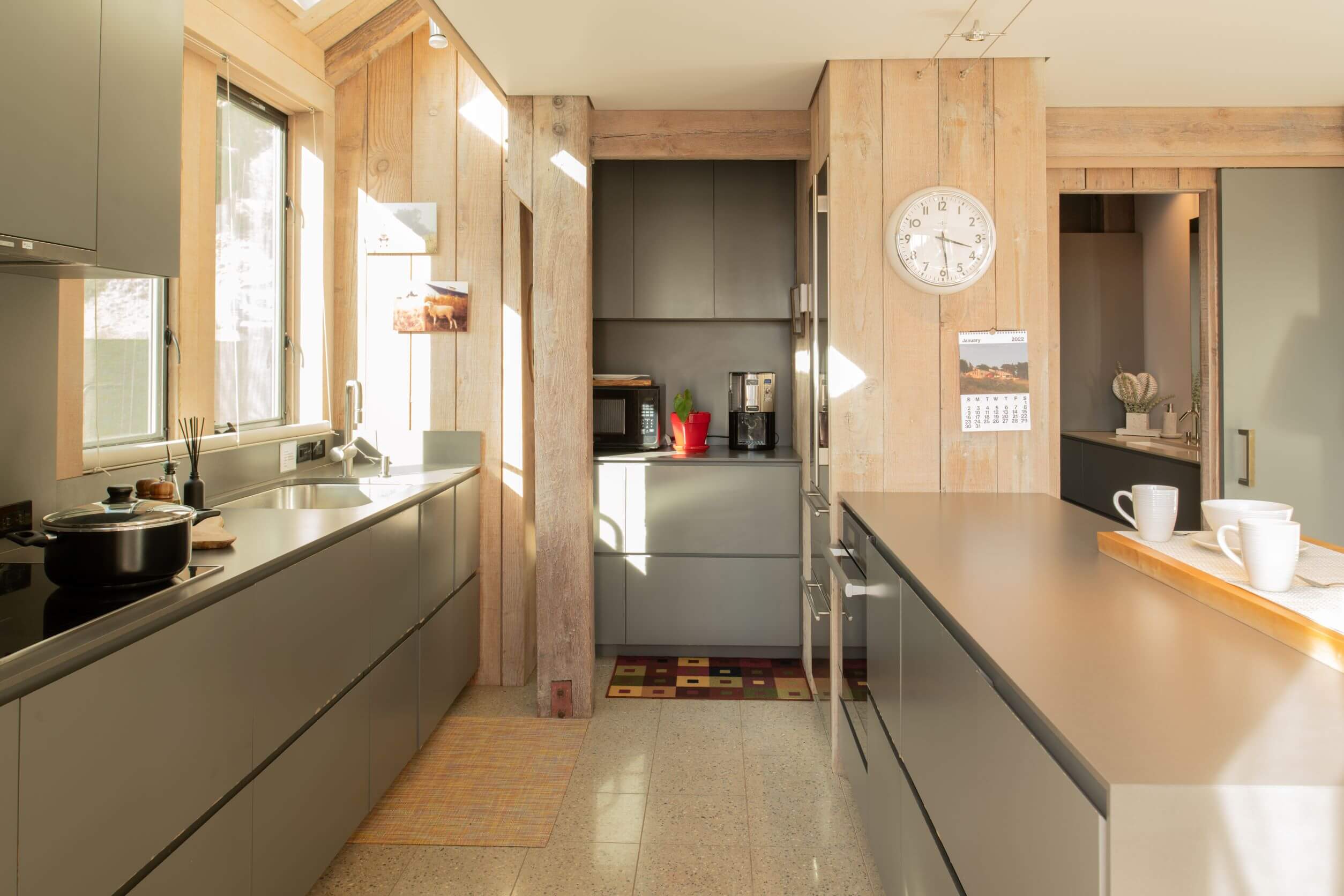 Seaview: bright kitchen with sleek gray counters and wood walls.