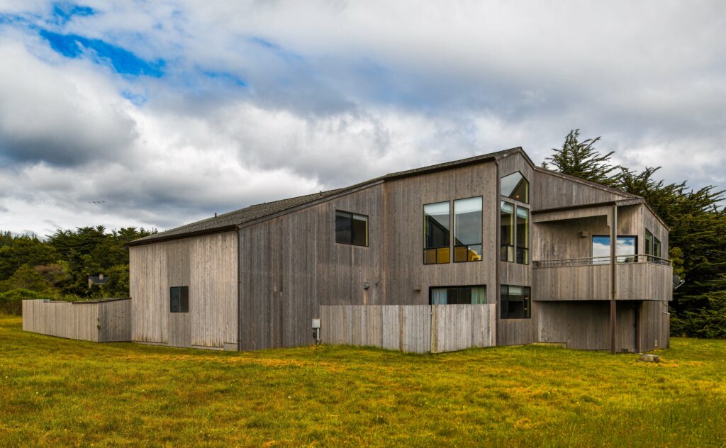 Mare Vista: exterior view of home on green grass against blue sky.