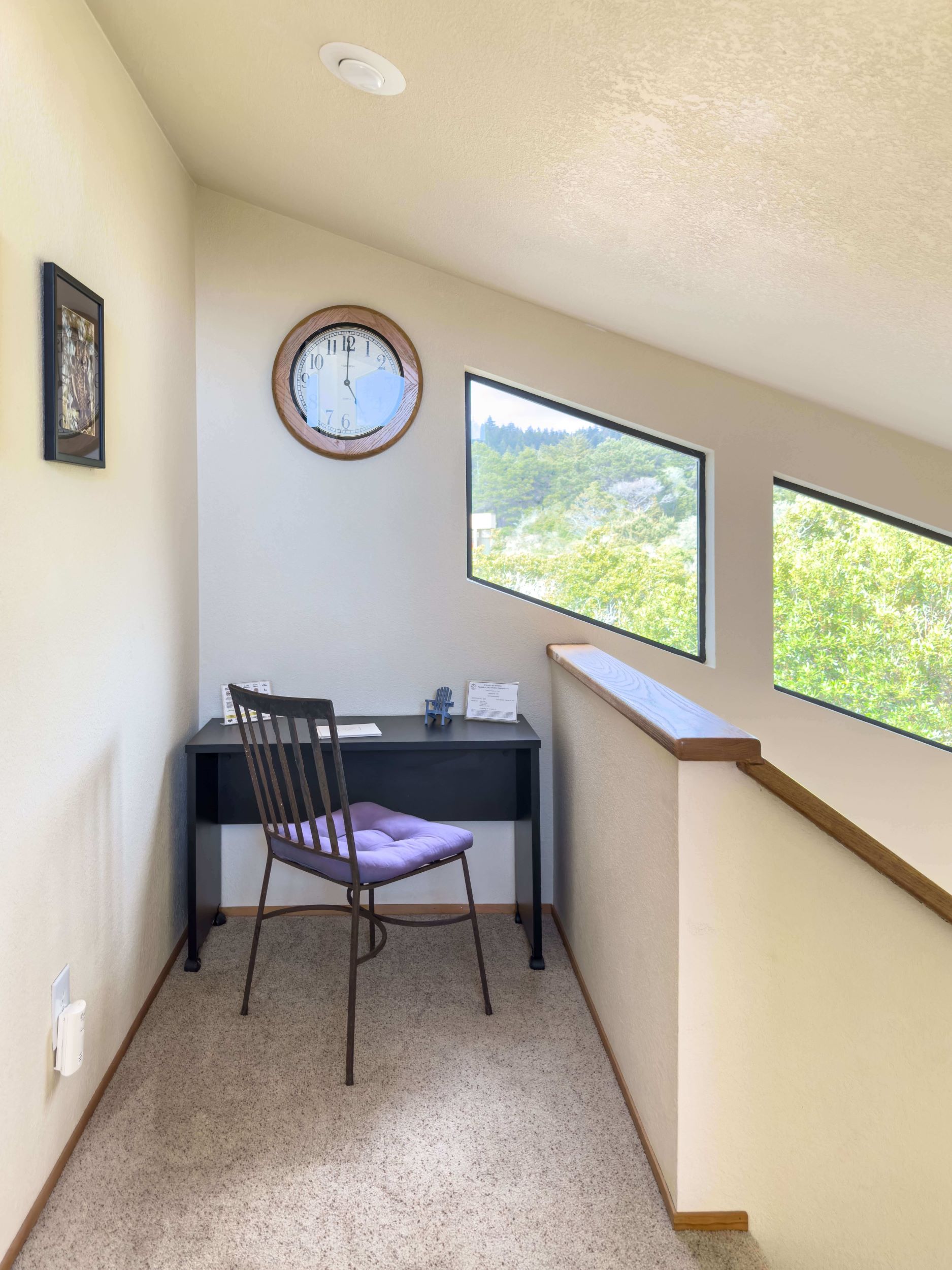 Mare Vista - bright stair landing with small desk and chair on carpet.