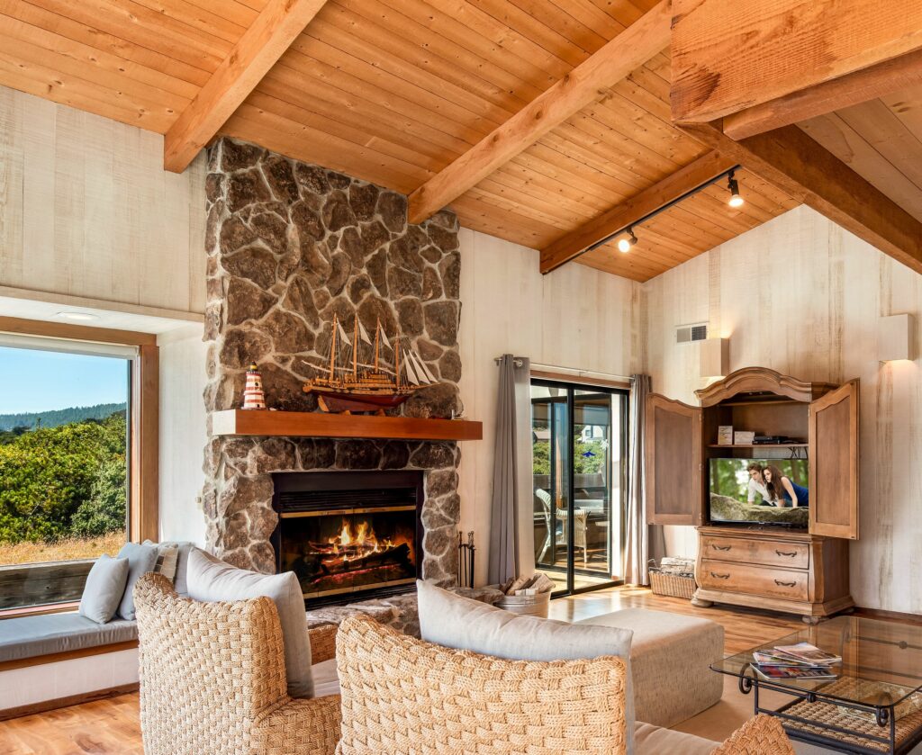 Cove Overlook: high wood ceiling living room with wood burning fireplace and wood floors.