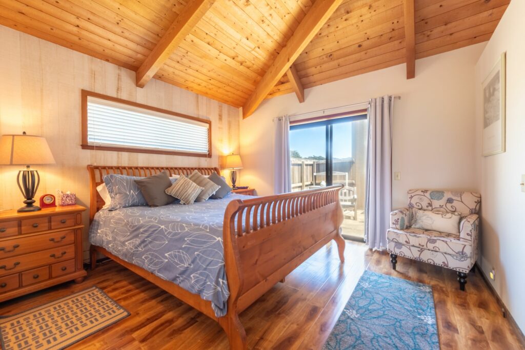 Cove Overlook: cozy bedroom with wood ceiling and door to outside patio