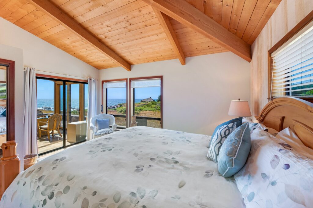 Cove Overlook: bright bedroom with view of enclosed patio.
