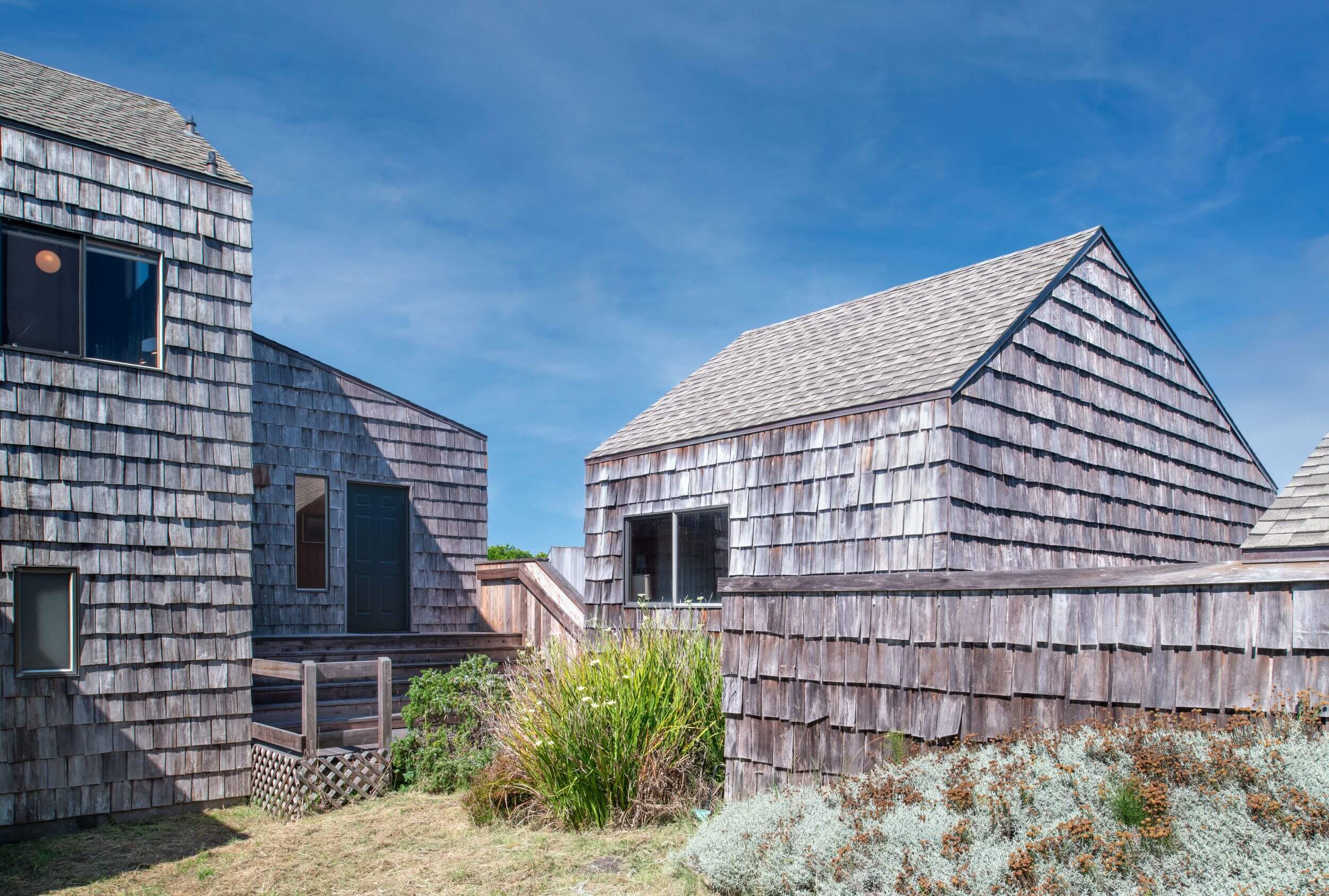 Sea Meadow: outdoor view of shingled home entrance against blue sky