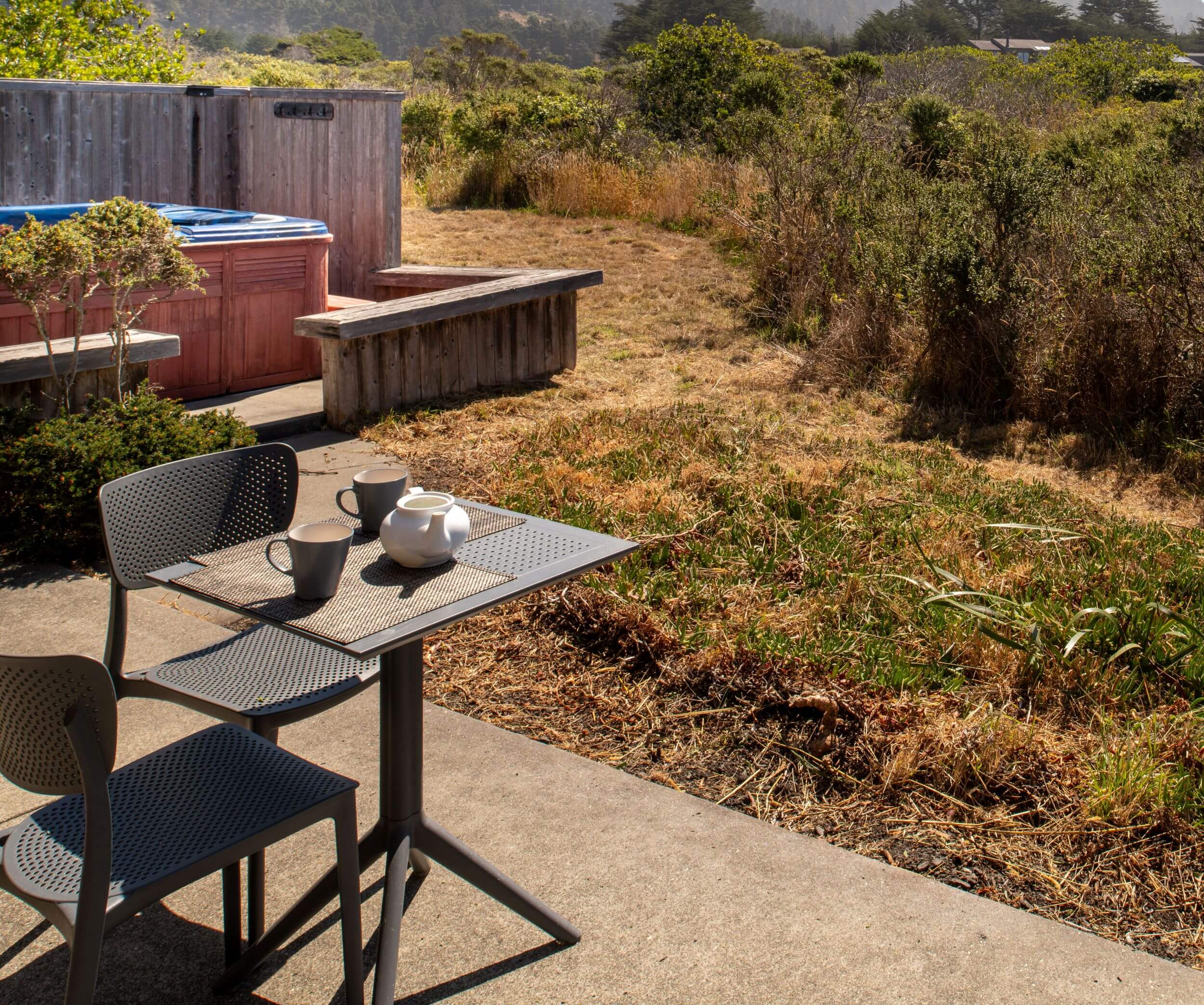 Sea Meadow: outside meadow view of small bistro table and chairs with view of hot tub