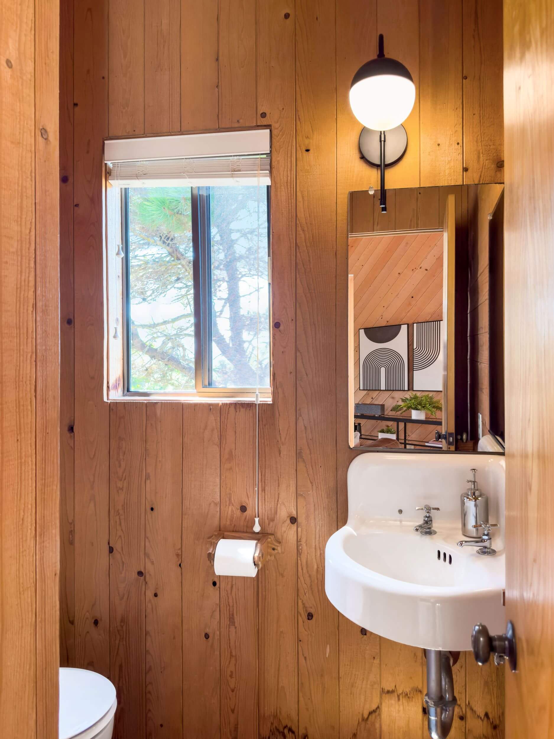 Sea Meadow: 1/2 bathroom with wood walls, small sink and small window.