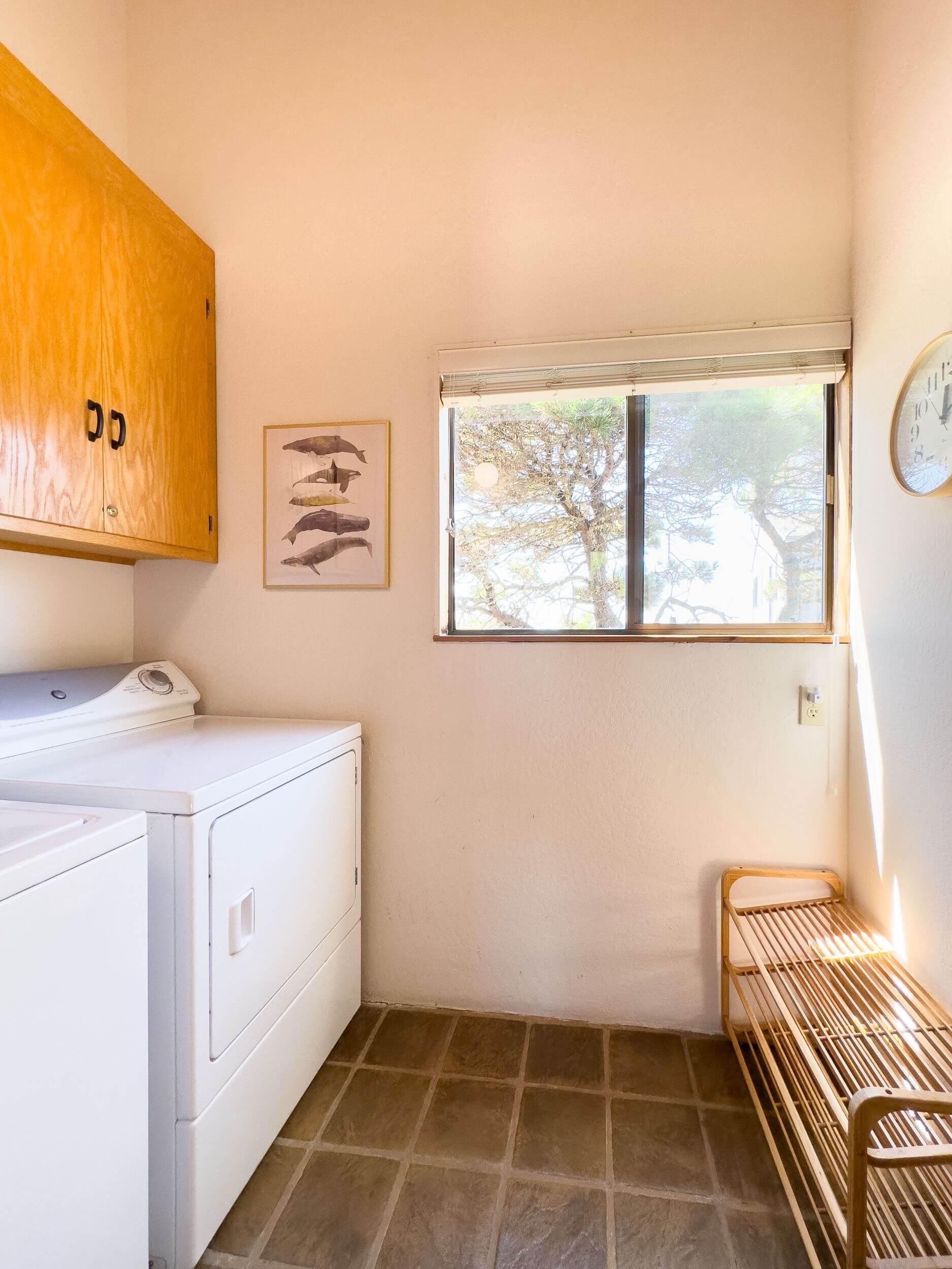Sea Meadow: bright laundry room with tiled floor and window.