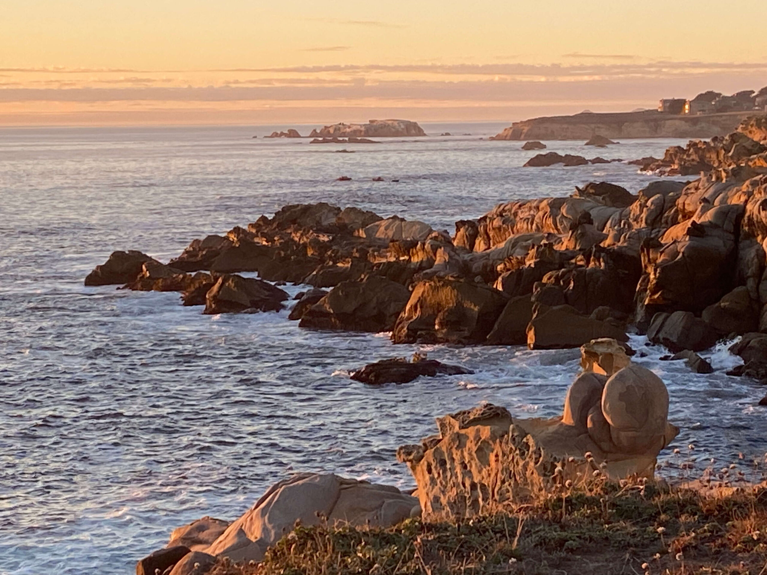 Brown Pelican Retreat - sunset view of rocky ocean.