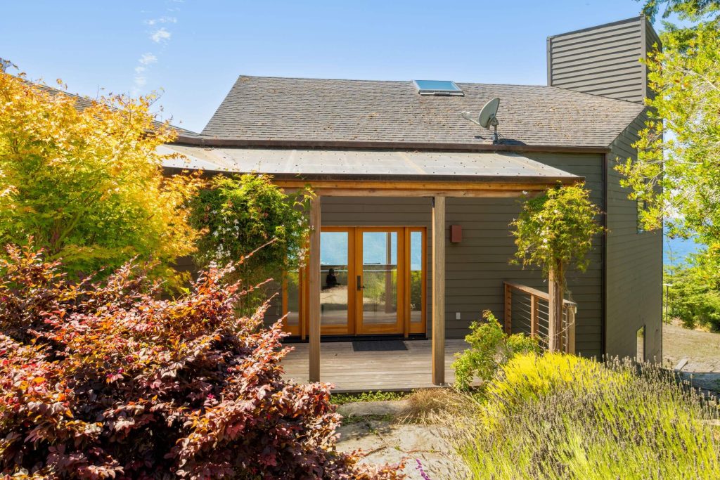 Cornwall West - exterior covered entry to shingled home surrounded by plants
