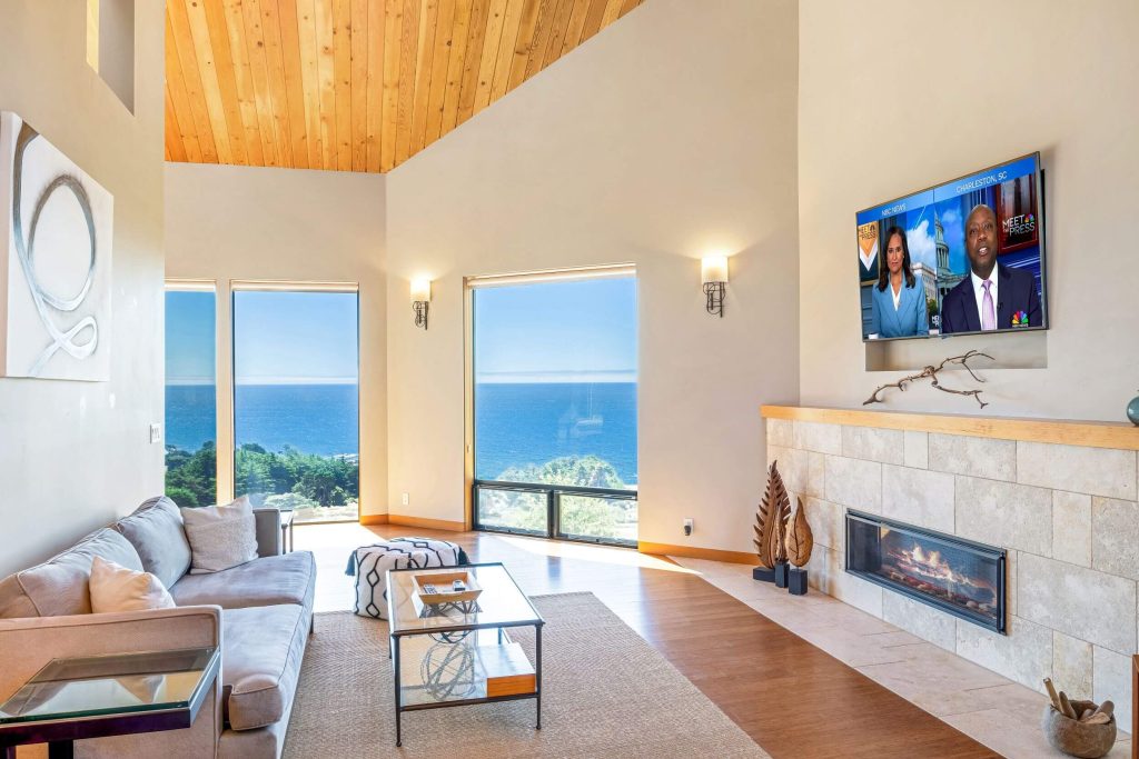 Cornwall West - bright second living room with large TV above gas fireplace.