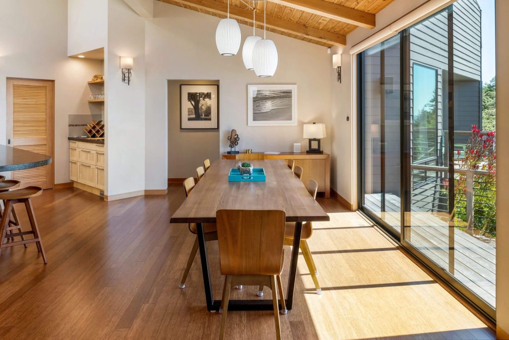 Cornwall West - large dining table and room with large sliding glass windows.
