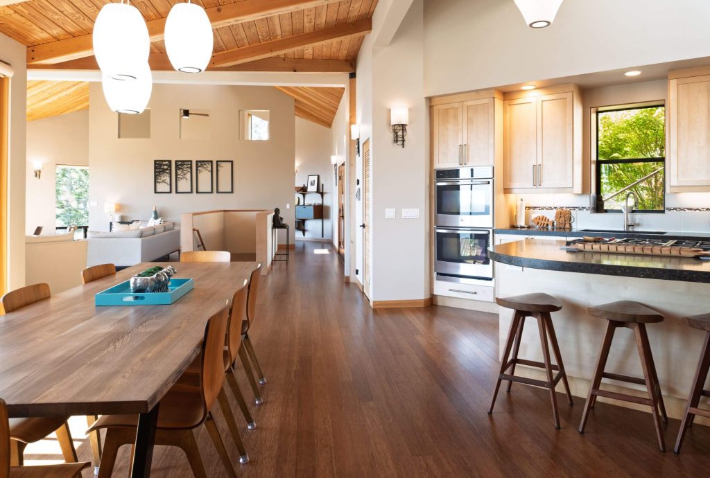 Cornwall West - large dining table and room with view into open kitchen.