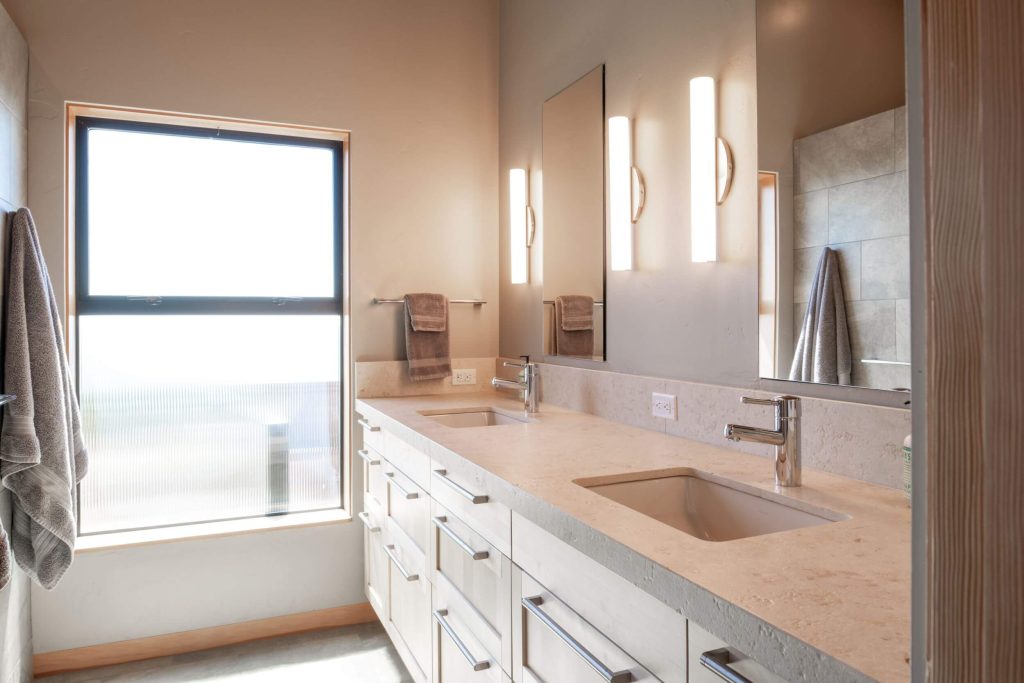Cornwall West - bright master bathroom with double sinks and many drawers.