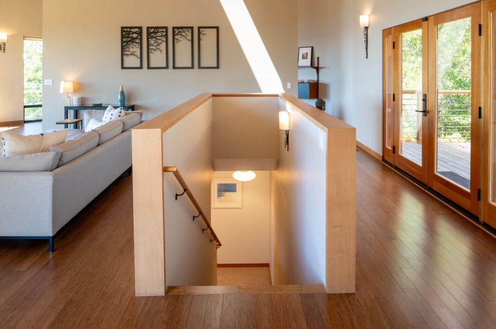 Cornwall West - stairs from main living room down to guest bedrooms.
